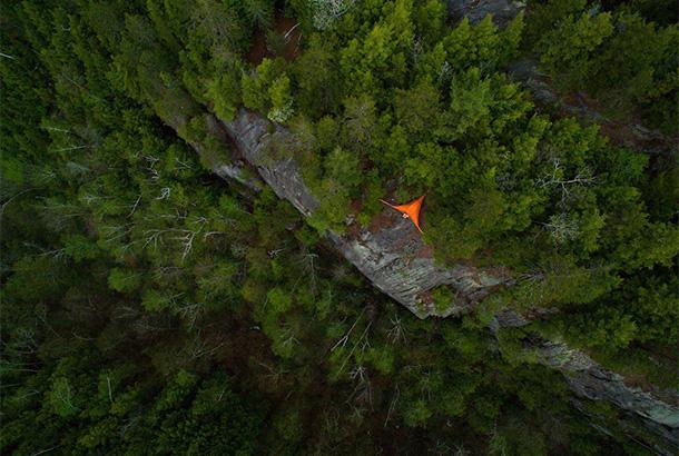 aerial shot of tent in woods