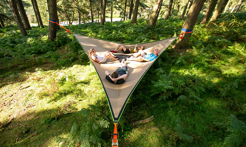 4 people laid in giant hammock in forest (4423357300809)