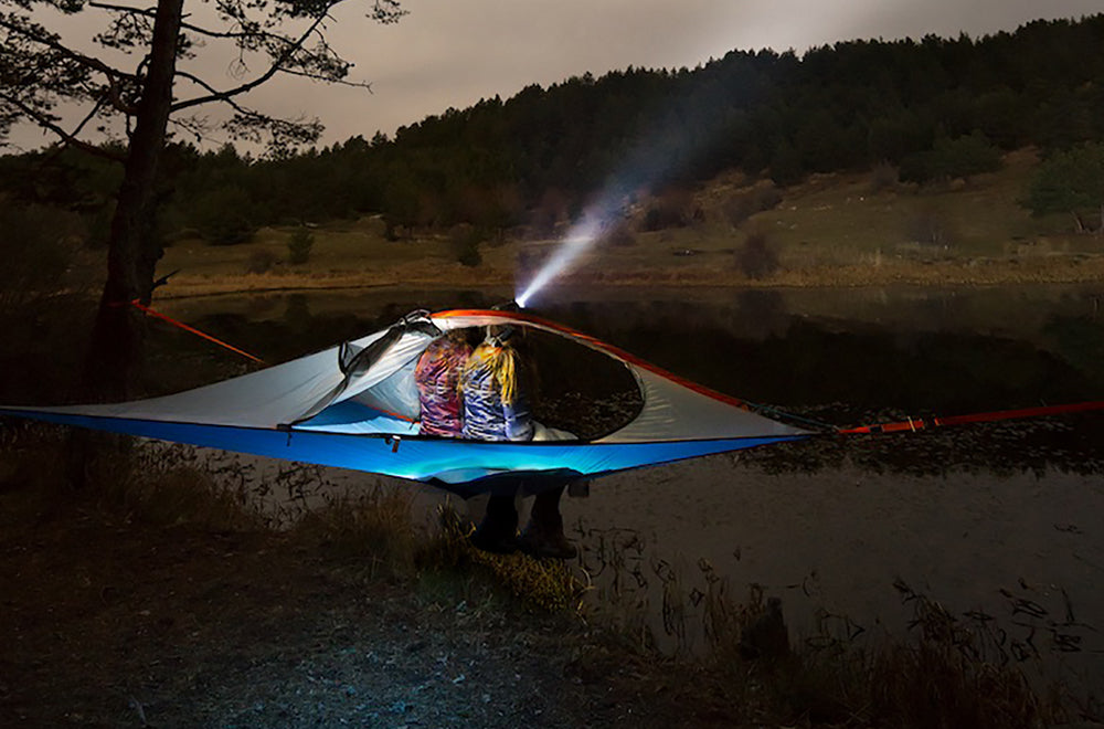 couple camping at dusk in tree tent (4351223234633)