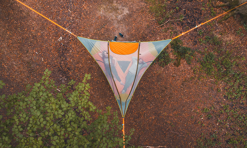 Aerial shot of couple in tree tent (6835887636553)