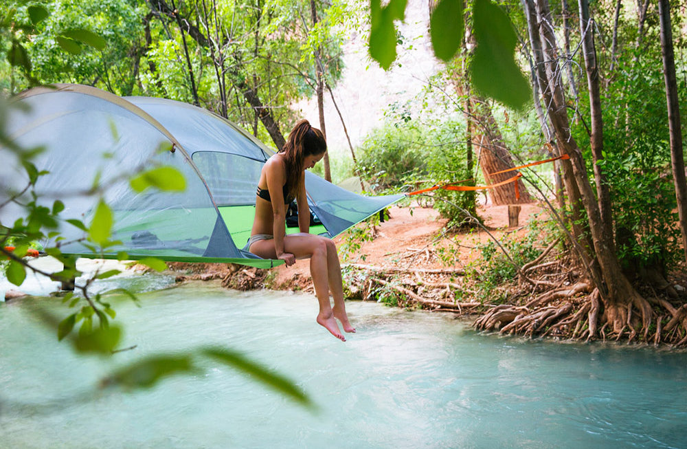 woman sat in tree tent over river (4351170936905)