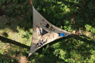 4 people laid in giant hammock in forest (4423357300809)