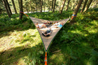 4 people laid in giant hammock in forest (4423357300809)